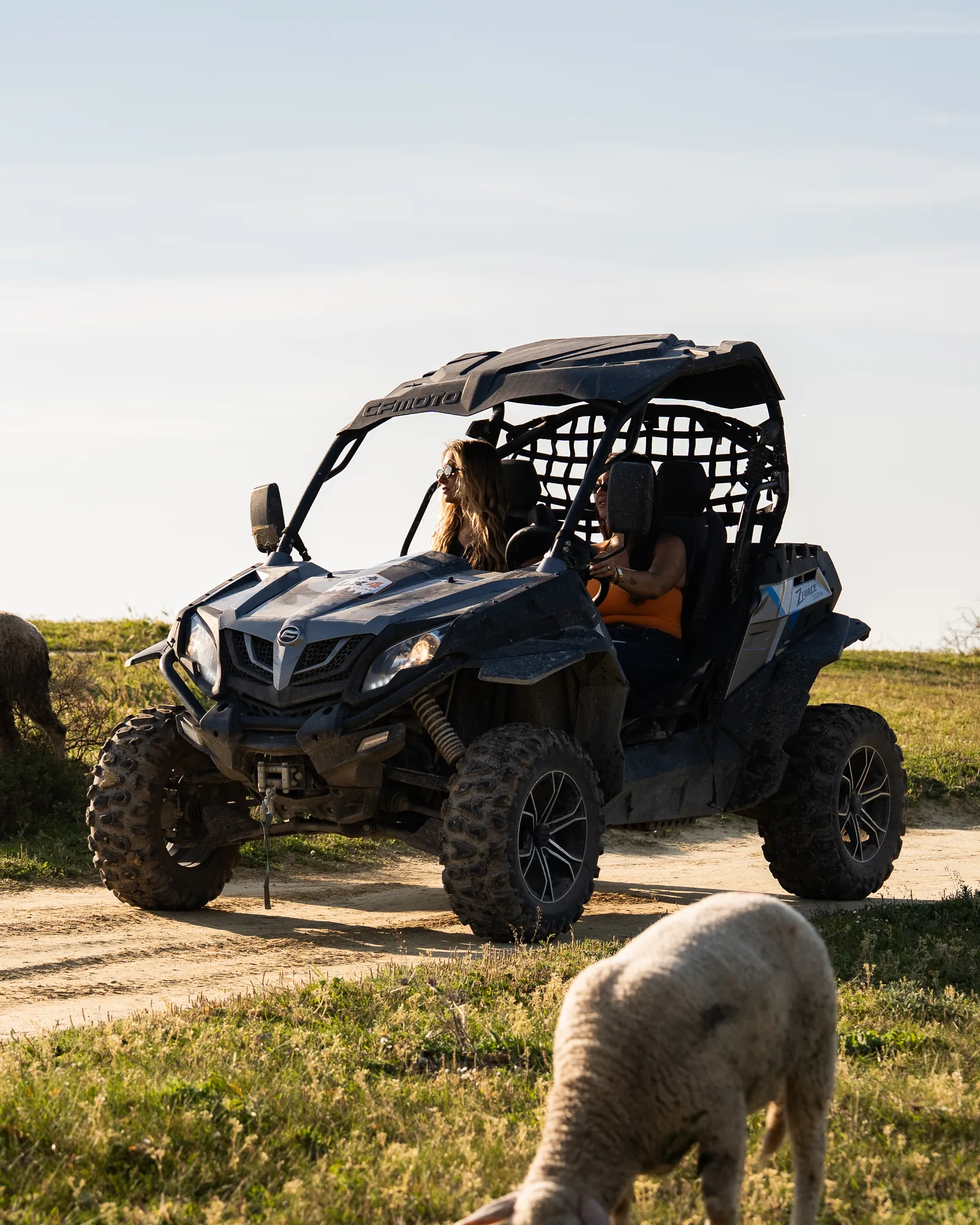 Two-seater off-road buggy on a coastal dirt trail in Costa da Caparica