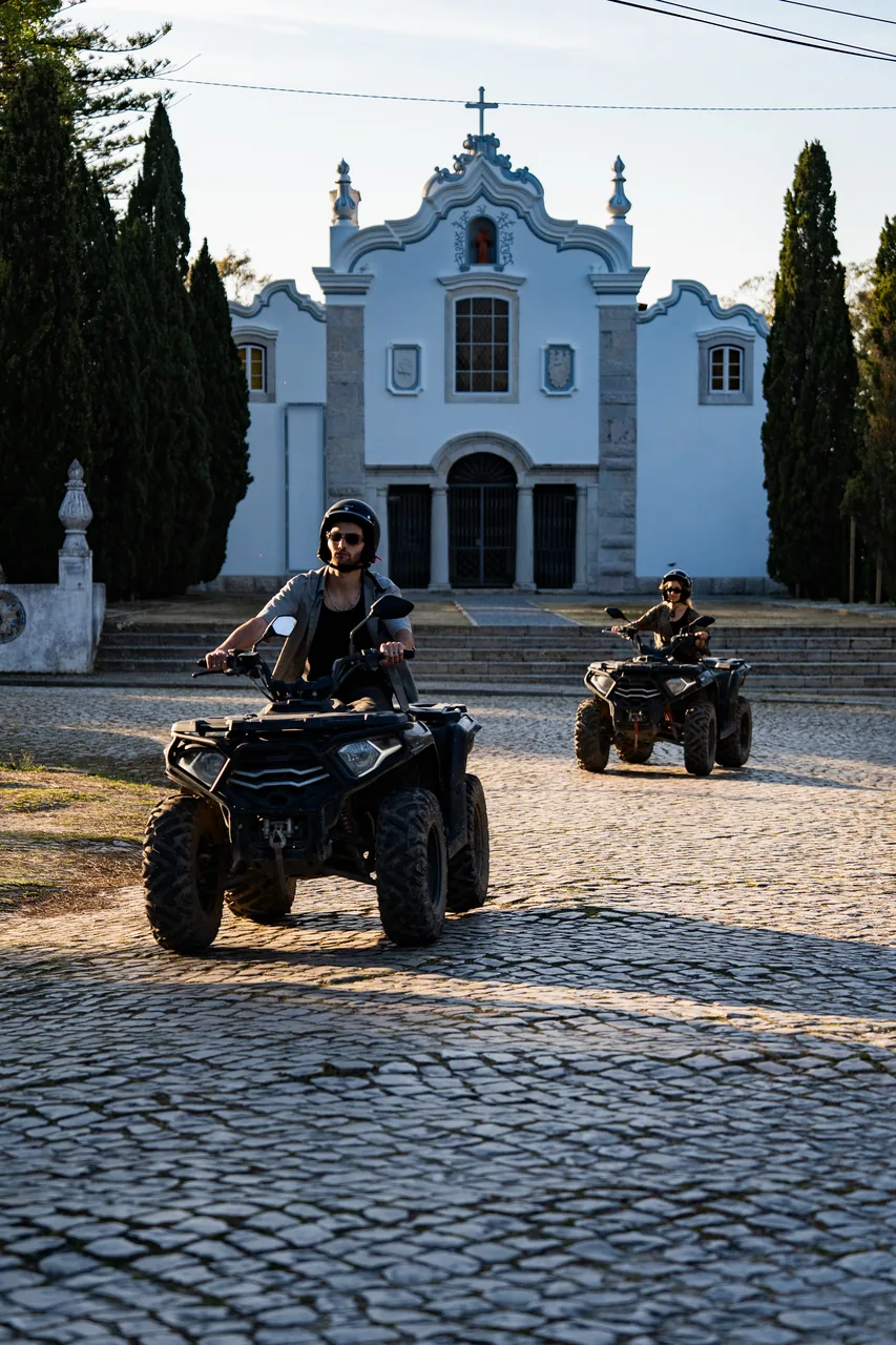 Quads in front of a whitewashed village church